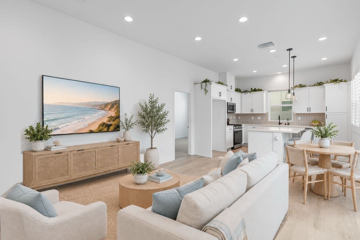 Your Living Room, Dining Area, Kitchen from the corner by the Stairway. Door to Main Floor Primary Suite in back middle. Glass Sliding Door to Private Patio just to the right. Photo virtually staged.
