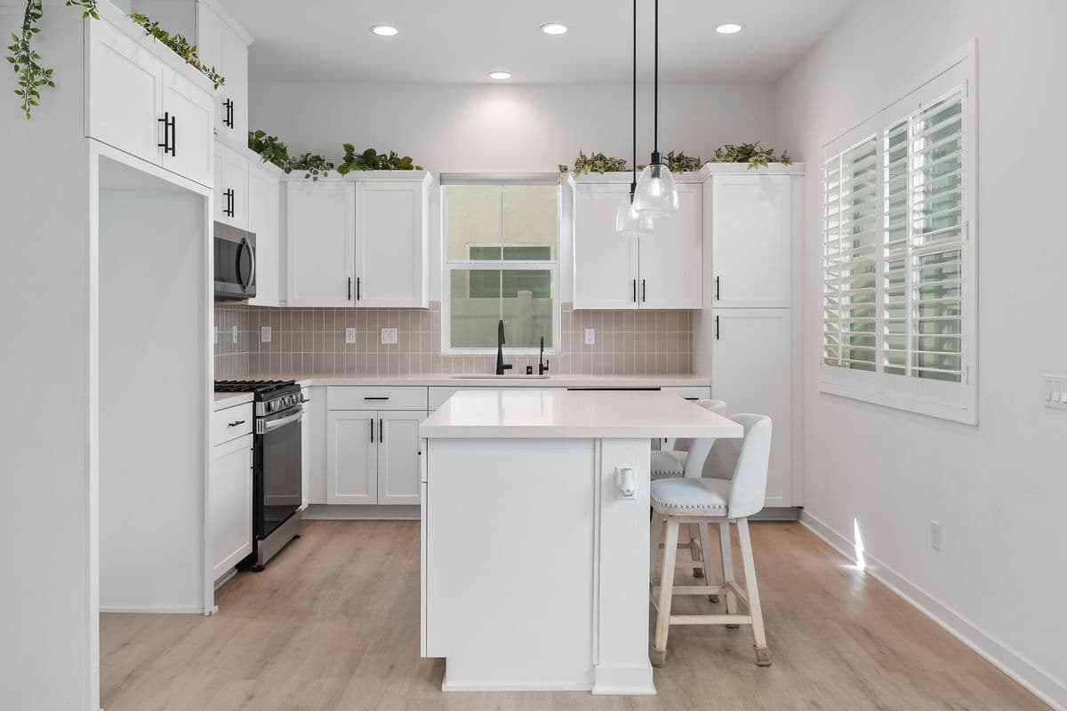 Your Kitchen from the Living Room. Outside Venting Microwave above Gas Stove. Sink with Water Filtration System in back with window out to your side yard.