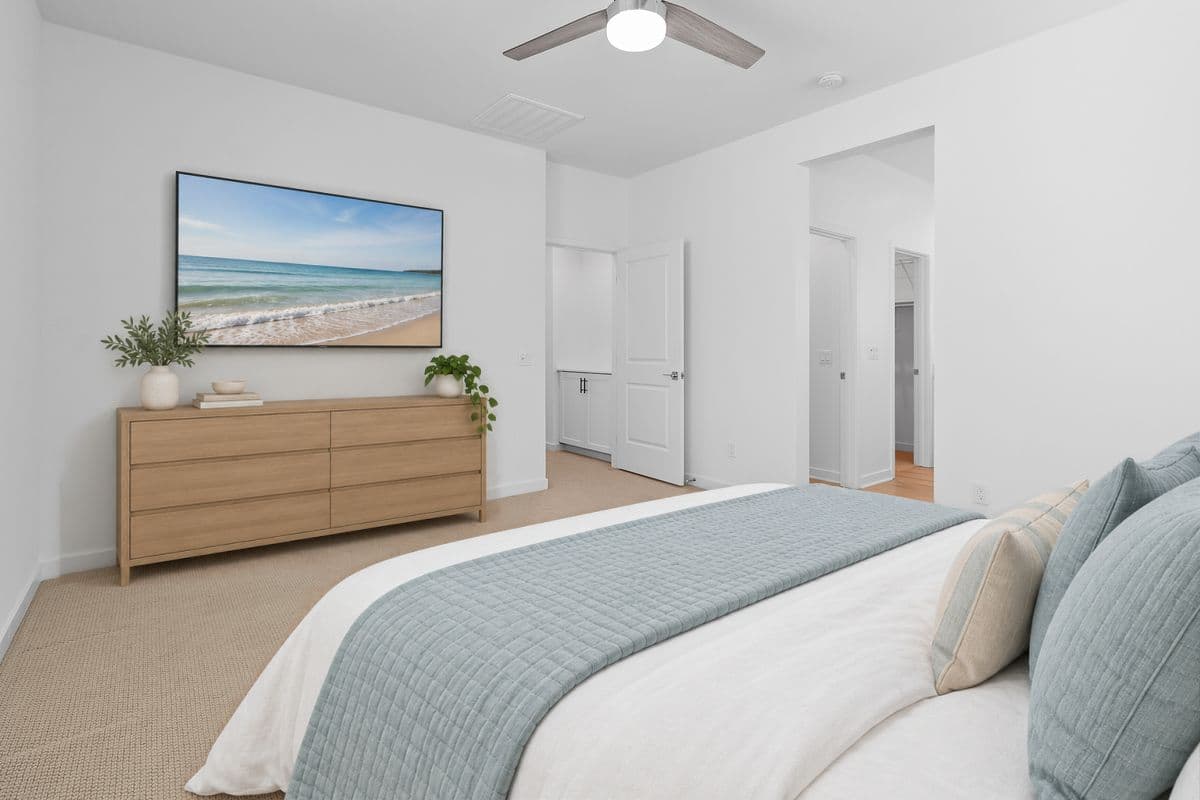 Your Top Level Primary Suite Bedroom from the opposite corner. Door to Hallway in back, middle with view of Hallway Storage Nook just outside the Bedroom door. Doorway to Bathroom and Walk-In Closet on the right. Photo virtually staged.