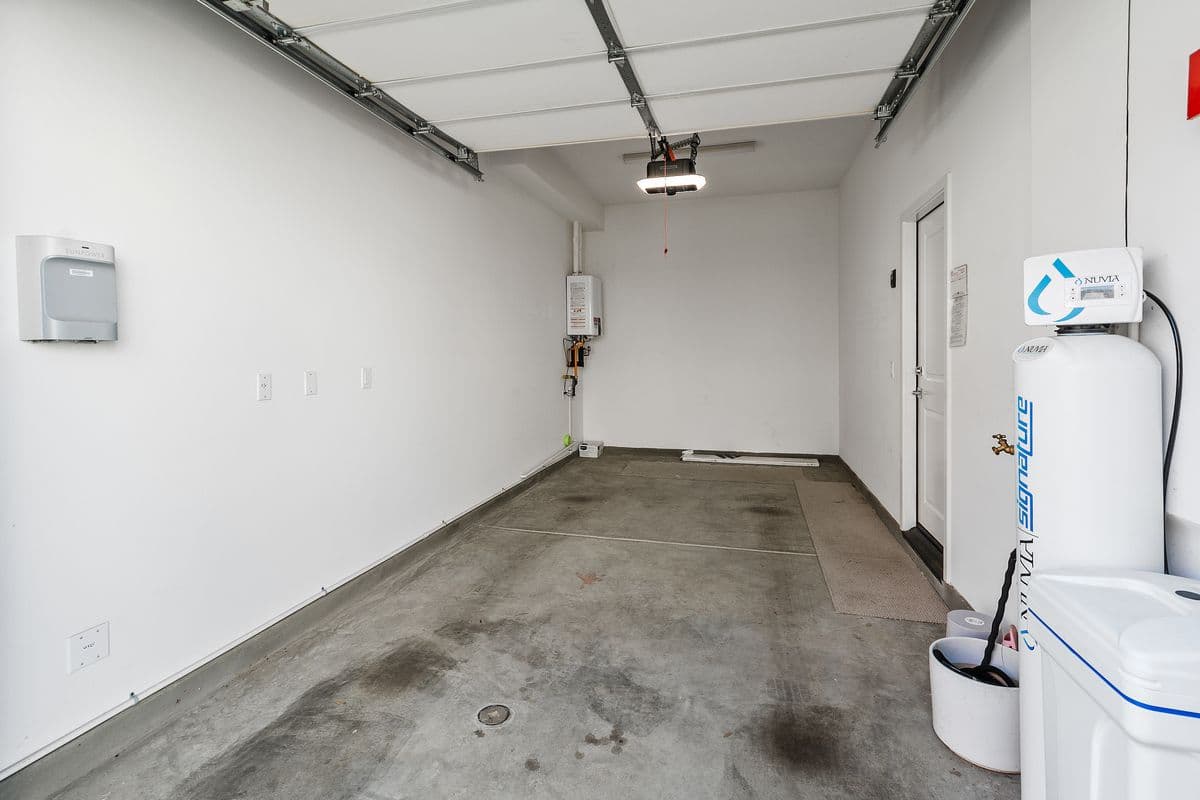 Your Garage. Deep enough for lots of storage. Tankless Water Heater on the back left wall. Water Softener on the front right.