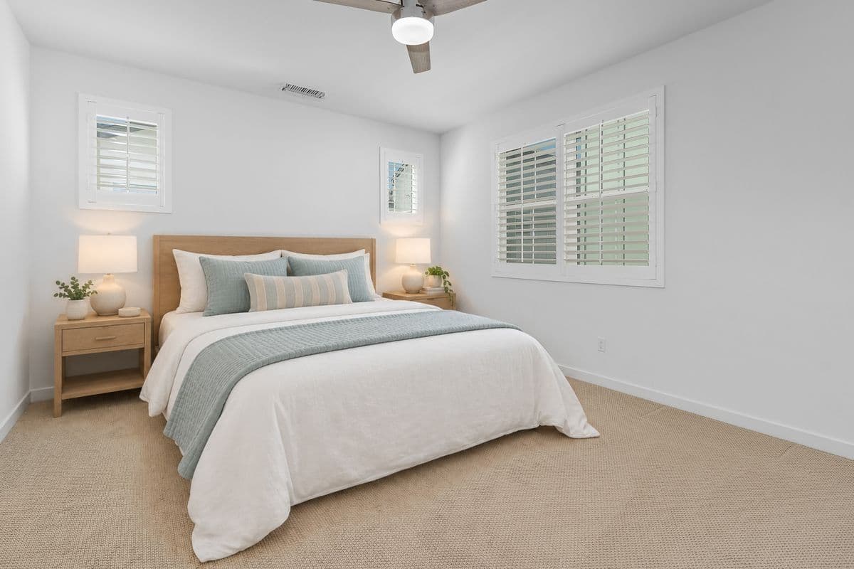 Your Top Level Primary Suite Bedroom from the doorway. Back windows above Side yard. Window on the Right above Private Patio. Photo virtually staged.